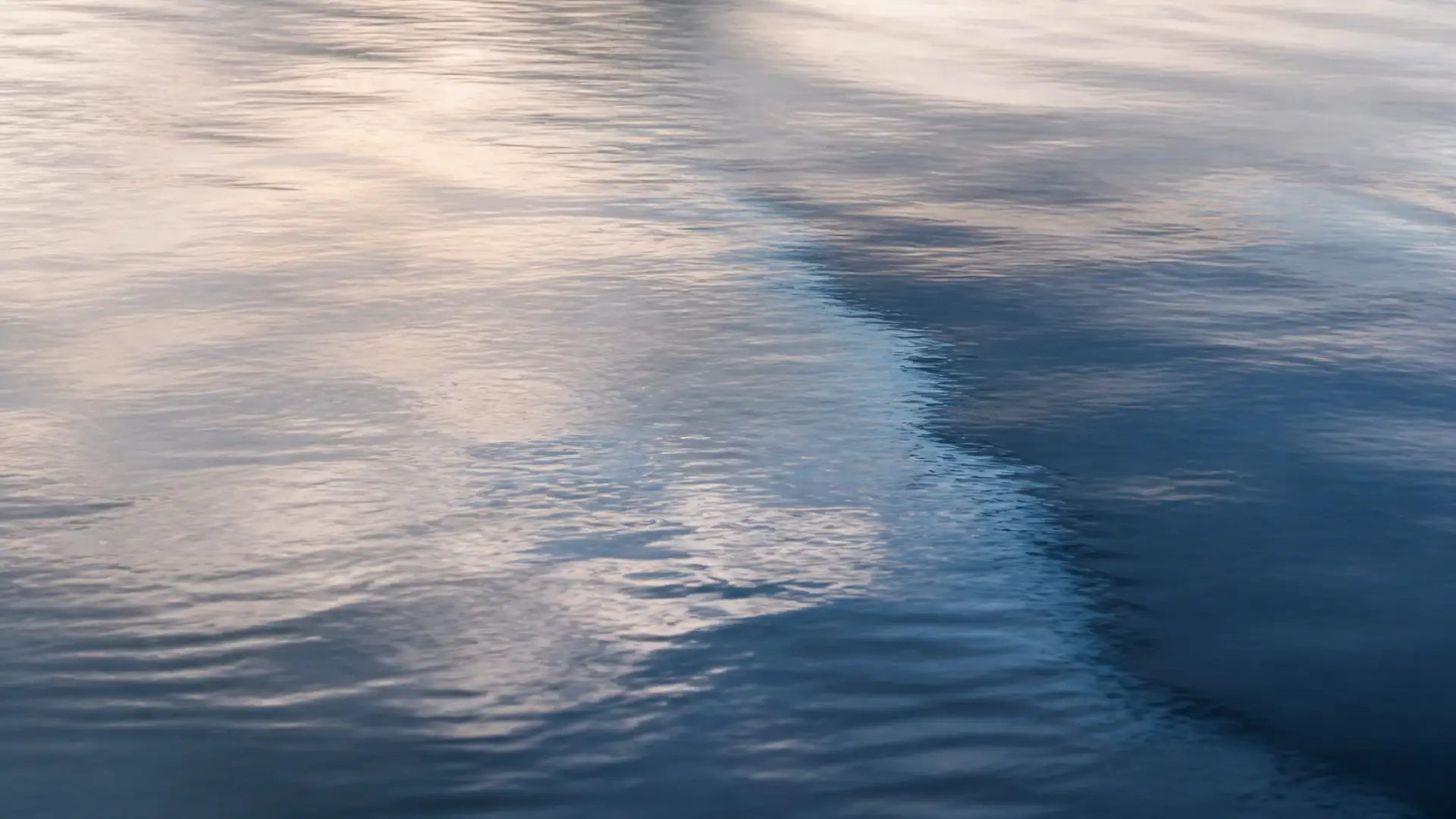 Soft dawn light reflected across still tidal water